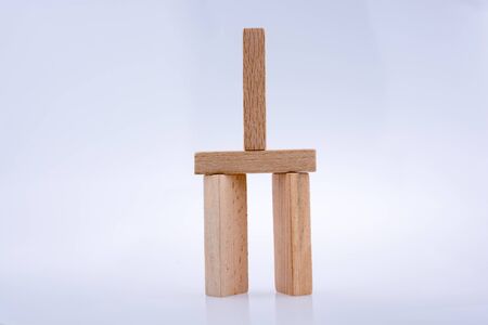 Wooden domino  pieces positioned on white backgroundの写真素材