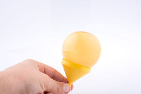 Balloon in a funnel on white background