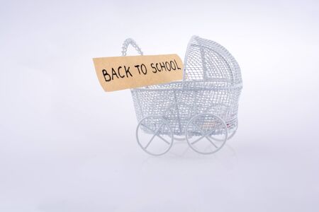 Toy  baby carriage made of metal on white background has a signの写真素材