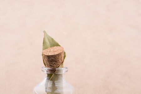 Little empty glass bottle in hand on a white backgroundの写真素材
