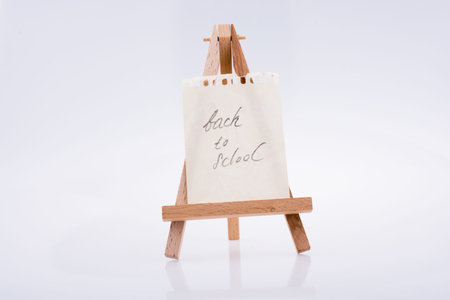Back to school written paper on a painting tripod
