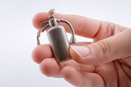 model fire extinguisher key holder in handの写真素材
