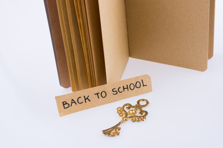 Notebook, key and  and back to school title on a notebookの写真素材