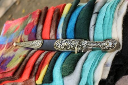 Ancient style dagger on fabric in Bazaar  of Tbilisiの写真素材
