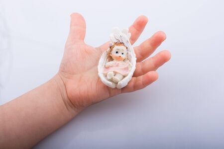 Little baby figure in hand on a white backgroundの写真素材