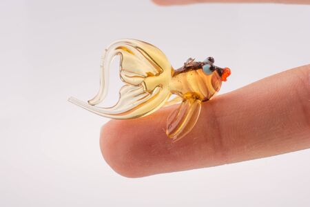 Beautiful colorful fish made of glass on white backgroundの写真素材