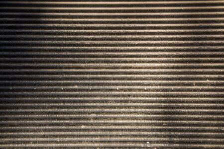 Straight lines on a shop front shutter as a metal backgroundの写真素材