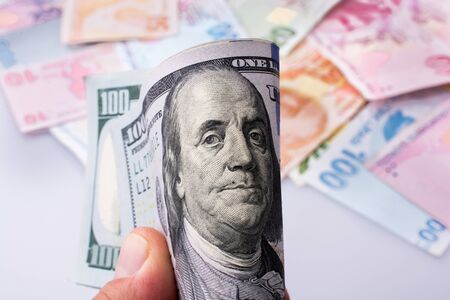 American dollar banknotes and Turksh Lira banknotes side by side on white backgroundの写真素材