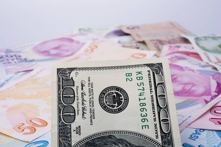 American dollar banknotes and Turksh Lira banknotes side by side on white backgroundの写真素材