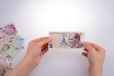 Hand holding Turksh Lira banknote  on white background