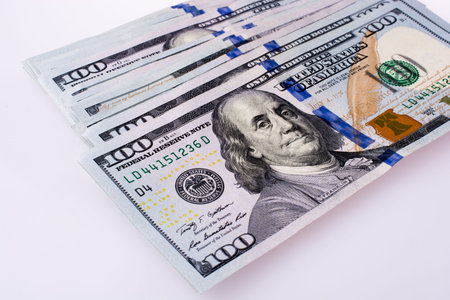 American 100 dollar  banknotes made of paper placed on white background