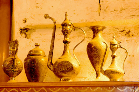 Ancient metal jug in oriental style  in antique marketの写真素材