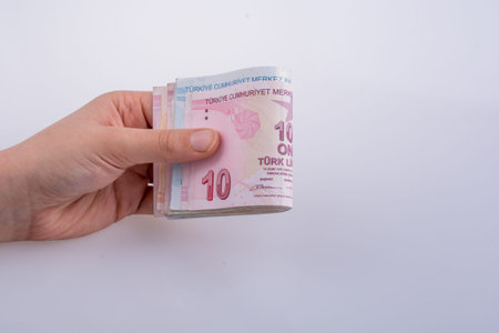 Hand holding Turksh Lira banknotes  on white background