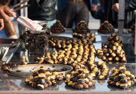 Organic brown chestnuts roasted over a hot fireの写真素材