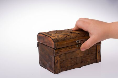 hand holding a brown wooden case   on a white backgroundの写真素材