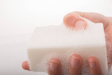 Hand washing and soap foam on a foamy backgroundの写真素材