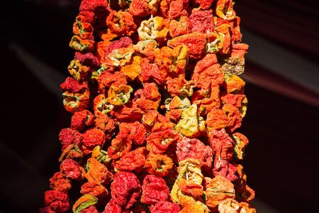 Bundles of red peppers dry in the sunの写真素材