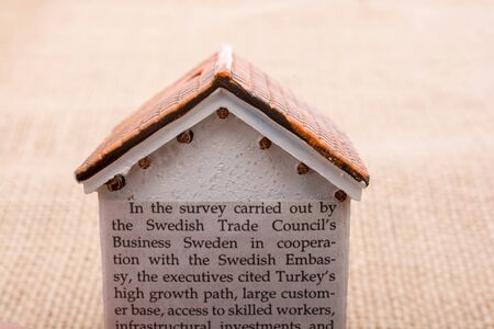 Little model house   and a paper with text aroundの写真素材