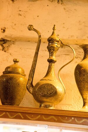 Ancient metal jug in oriental style  in antique marketの写真素材