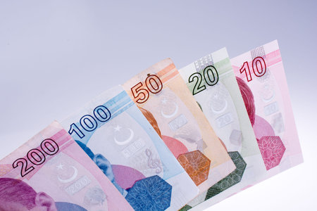 Turksh Lira banknotes of various color, pattern and value on white background