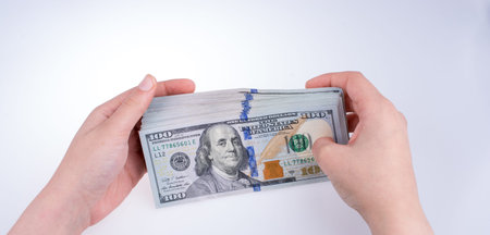 Human hand holding American dollar bill as money isolated on white