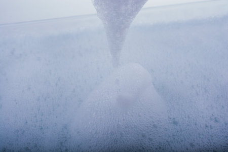 Pure water covered with foam of shampoo