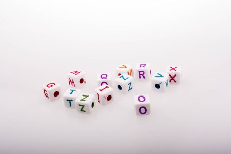 Colorful alphabet letter cubes on a white backgroundの写真素材