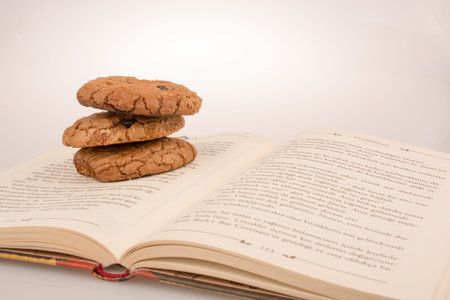 Chocolate chip cookies placed on a bookの写真素材