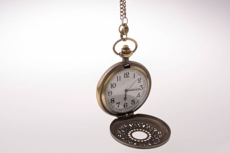 Retro style pocket watch on white backgroundの写真素材
