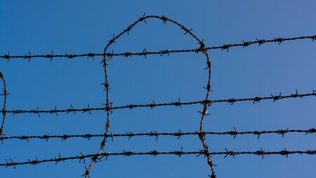 barbed wire fence  used for protection purposes of a ppropertyの写真素材