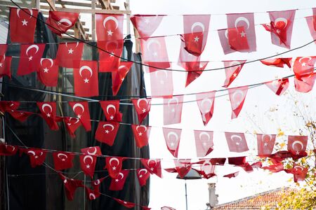 Turkish national flag hang on a pole on a rope in the street in open airの写真素材