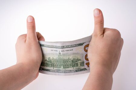 Human hand holding American dollar bill as money isolated on whiteの写真素材