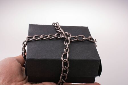 Gift box of black color  on brown backgroundの写真素材