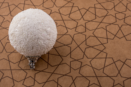 White color decorative ball on a paper with a patternの写真素材