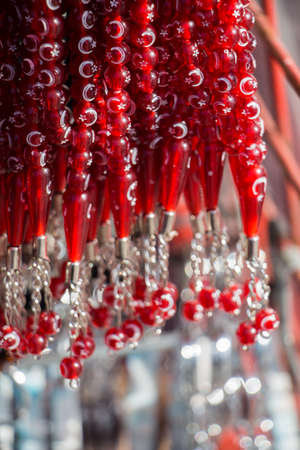 Red color beads with crescent and star shapesの写真素材
