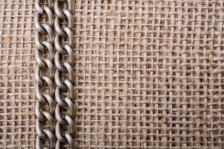 chain on a linen canvas as a background textureの写真素材