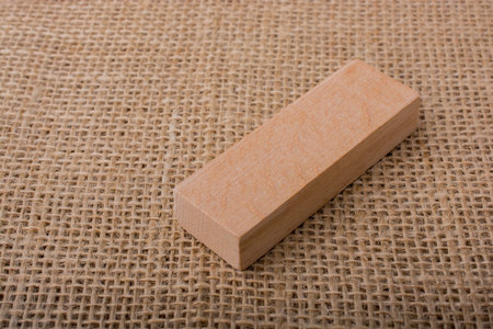 Wooden domino  on a  linen canvas background