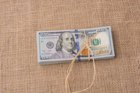 Banknote bundle of US dollar tied with colorful a ribbonの写真素材