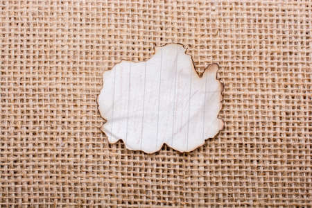 Piece of  burnt paper placed on a linen canvasの写真素材