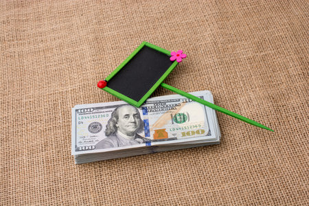 Notice board placed on the bundle of US dollar banknoteの写真素材