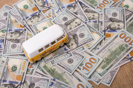Model van placed US dollar banknotes spread on groundの写真素材