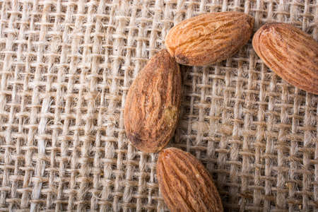 Almonds placed on a linen canvas backgroundの写真素材