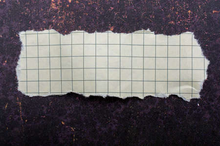 Torn paper placed on a dark backgroundの写真素材
