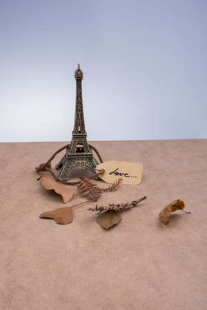 Eiffel tower and dry leaves on a brown backgroundの写真素材