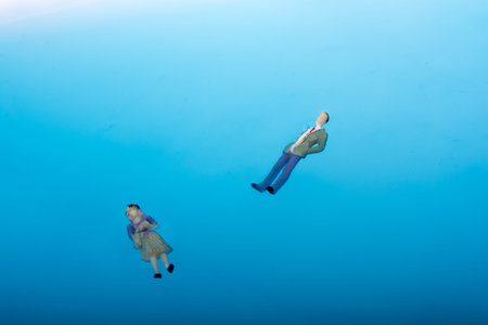 Little floating figurines in blue water