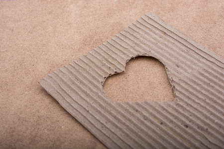 Heart shaped cut out of a brown cardboardの写真素材