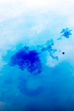 Watercolor paint dissolving in pure water
