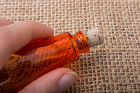 Colorful empty bottle placed on a linen canvas