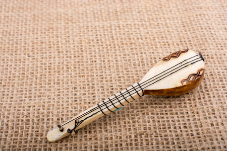 Model of Turkish musical instrument saz on a linen canvasの写真素材