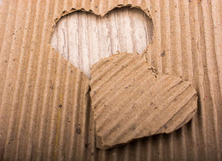 Heart shaped cut out of a brown cardboardの写真素材